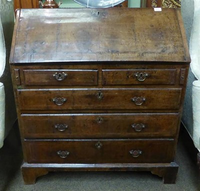 Lot 896 - An early 18th century walnut bureau, with sloped fall front enclosing a fitted interior, with...