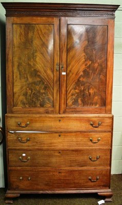 Lot 903 - A George III mahogany linen press with blind fret frieze