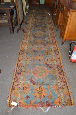 Lot 913 - Narrow Ushak runner, west Central Anatolia, the abrashed indigo field with a single column of...