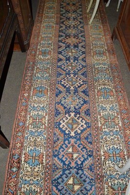 Lot 914 - Narrow Heriz runner, Persian Azerbaijan, the indigo field with a column of polychrome hooked...