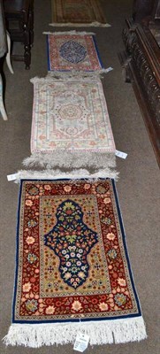 Lot 916 - Hereke Silk rug, North West Anatolia, the mid blue field with flowers and plants framed by...