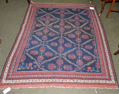 Lot 927 - Afshar rug, South East Persia, the midnight blue diamond lattice field containing flowerheads...