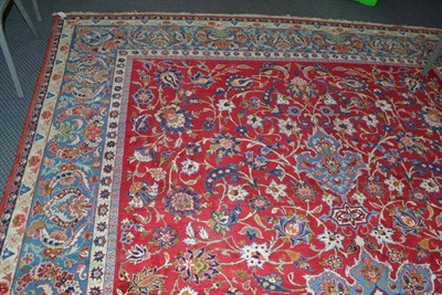 Lot 930 - Nejafad Isfahan carpet, central Persia, the crimson field of scrolling vines around a sky blue...