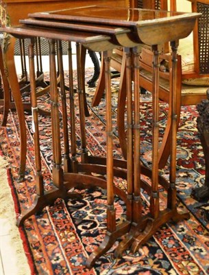 Lot 931 - Three rosewood nesting tables of graduated form raised on turned tapering legs