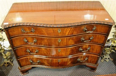 Lot 944 - A 1920's serpentine mahogany chest of drawers