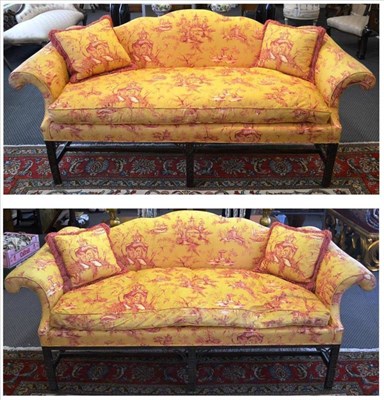 Lot 961 - A near pair of mahogany Chinese Chippendale style camel back sofas, 214cm wide