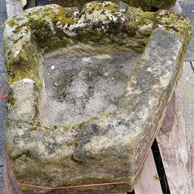 Lot 1401 - A garden triangular shaped stone trough, 90cm diameter