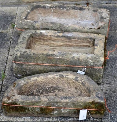 Lot 1410 - Two rectangular stone garden troughs, 65cm and 56cm wide; and D-shaped planter, 55cm wide