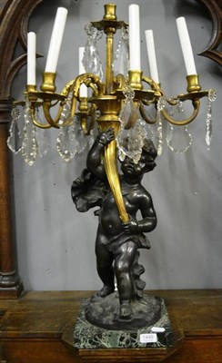 Lot 1449 - A bronze and gilt metal six branch candelabra with cut glass drops, 81cm high