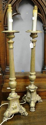 Lot 1450 - A pair of plated altar candlesticks in a 17th century style fitted for electricity, 85cm high