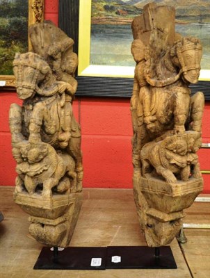 Lot 1470 - A pair of Nepalese wood carvings of warriors on rearing horses, 55cm and 51cm high