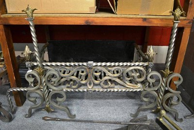 Lot 1489 - An impressive steel fire basket with andirons