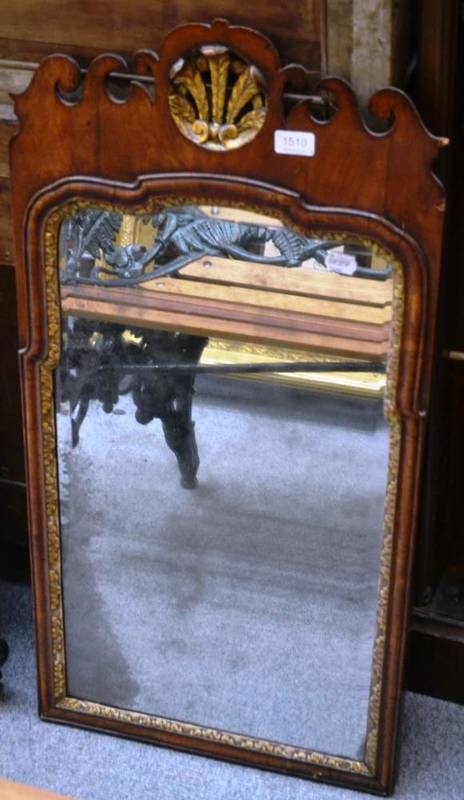 Lot 1510 - A George II walnut fretcut wall mirror, with parcel gilt Prince of Wales plume and gilded...