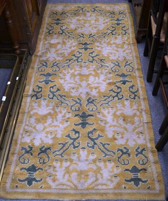 Lot 1521 - Spanish rug, the soft mustard field of stylised vines enclosed by plain borders, 234cm by 100cm