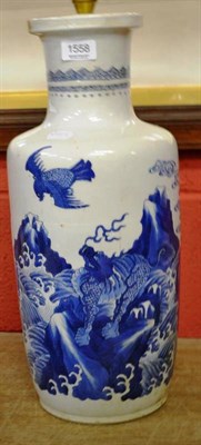 Lot 1558 - A Kangxi rouleau vase painted in underglaze blue with mythical blast and waves (damaged)