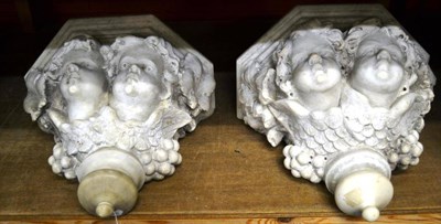 Lot 1563 - Pair of carved marble planters decorated with vines and figural heads, 41cm diameter