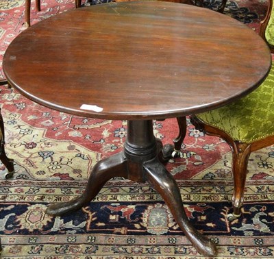 Lot 1608 - A George III mahogany tripod table, late 18th century, the circular flip top raised on a bird...