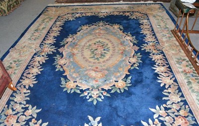 Lot 1609 - Blue ground Chinese rug, the deep indigo field of Savonnerie design enclosed by floral borders, 372