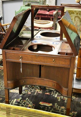 Lot 1613 - A George III mahogany washstand, circa 1800, with two hinged leaves enclosing a fitted interior...