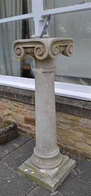 Lot 1638 - A natural stone ionic pedestal, of recent date, the top with inset modern bronze sundial plate,...