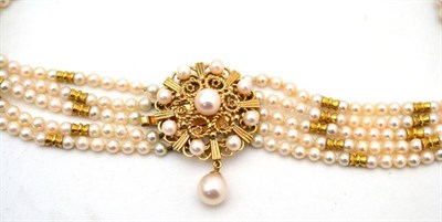 Lot 1 - A cultured pearl choker, five rows of cultured pearls with bow style spacers, to a round decorative