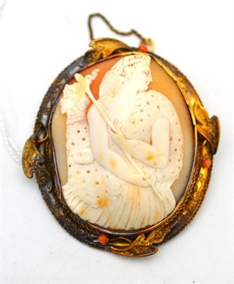 Lot 2 - A Victorian cameo brooch, the oval shell carved to depict a goddess, within an ornate frame...