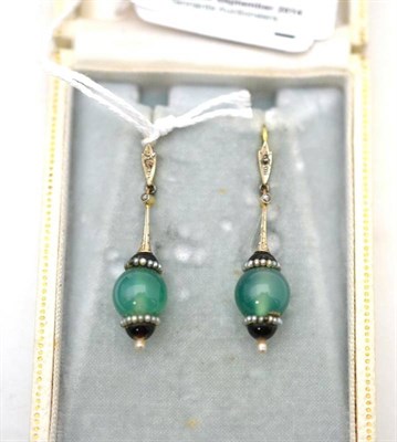 Lot 7 - A pair of Art Deco earrings, set with diamonds, onyx, seed pearls and a green hardstone, drop...