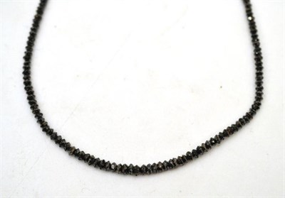 Lot 14 - A black diamond necklace, of graduated faceted beads, estimated diamond weight 20 carat...