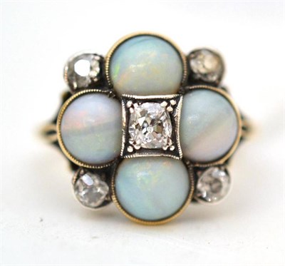Lot 19 - An opal and diamond cluster ring, five old cut diamonds and four round cabochon opals in white...