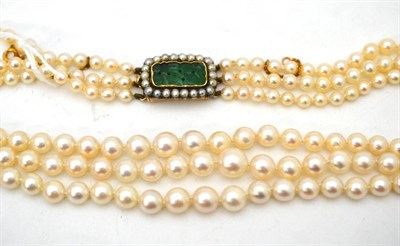 Lot 22 - A cultured pearl three row choker, with jade and pearl cluster clasp, length of shortest strand...