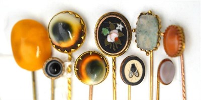 Lot 36 - Nine assorted stick pins, set with assorted stones including amber, pietra dura examples, operculum