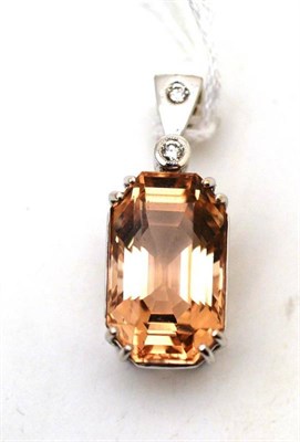 Lot 43 - A topaz and diamond pendant, the emerald-cut peach coloured topaz in a white double claw...