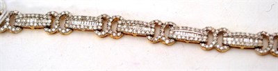 Lot 47 - A 9ct gold fancy link diamond bracelet, the links with graduated baguette cut diamonds within...
