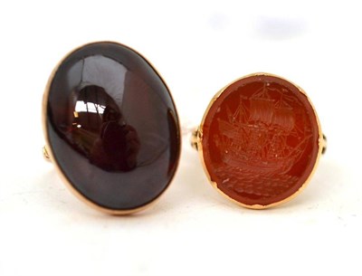 Lot 57 - An intaglio ring with a cornelian carved as ship, finger size M approximately, and a carbuncle...