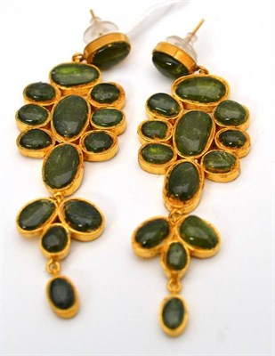 Lot 58 - A pair of green tourmaline earrings, cabochon green tourmaline inset into long drops, with post...