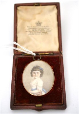 Lot 63 - A miniature watercolour of a young girl, 4.2cm high by 3.4cm wide, in a Garrards leather box