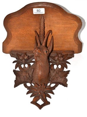 Lot 80 - A limewood carved wall bracket supported by the head of a stag, 26cm high