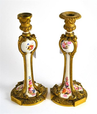 Lot 112 - A pair of late 19th century French ormolu and porcelain candlesticks with removable nozzles,...