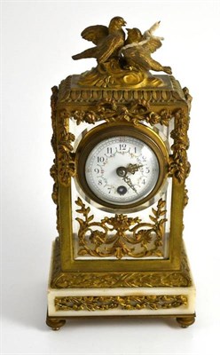 Lot 115 - A French gilt metal mantel timepiece, circa 1900, bevel glass panels, enamel dial with Arabic...