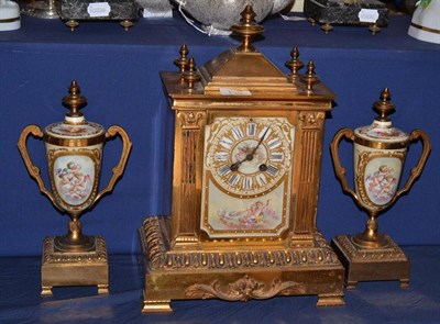 Lot 130 - A gilt metal and porcelain mounted striking mantel clock with garniture, circa 1900, porcelain dial