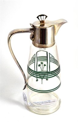 Lot 143 - A Secessionist Movement claret jug with green enamel decoration and plated mount, 28cm high