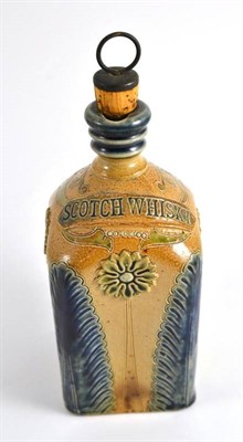 Lot 181 - A stoneware spirit flask, by Bailey of Fulham, labelled SCOTCH WHISKY, incised and floral...