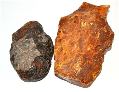 Lot 187 - A Copal boulder, of dark orange tone, 15cm long; and a Copal boulder, of mid orange tone, 21cm long