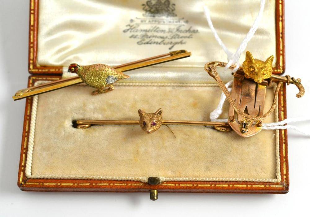 Lot 232 - A 9ct gold fox mask brooch, length 5.2cm, cased, a fox and crop clip, measures 3.7cm by 3cm,...