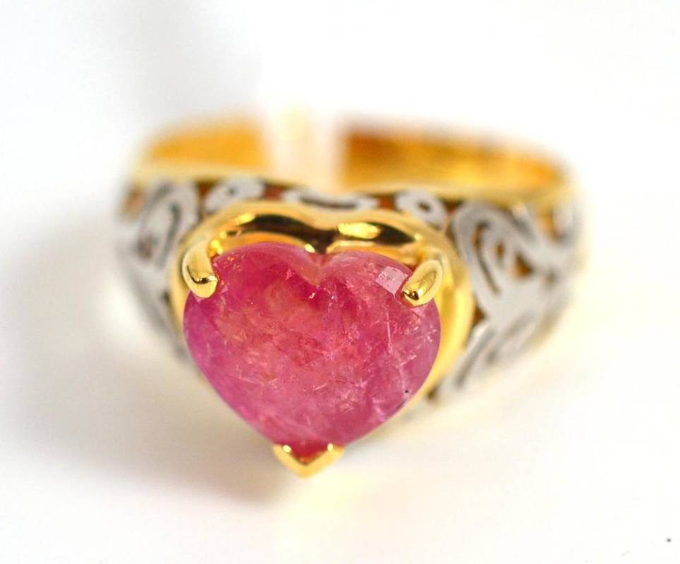 Lot 259 - An 18ct gold bixbite ring, the facetted heart shaped red stone on a decorative pierced shoulder...