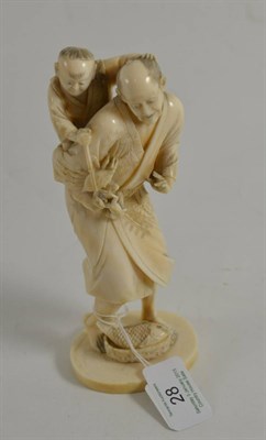 Lot 28 - A Japanese ivory okimono of a fisherman and child, height 18cm