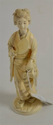 Lot 31 - A 19th century Japanese Meiji period carving of Bijin holding a fan, 18cm high