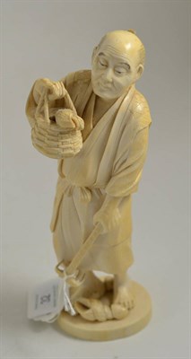 Lot 32 - A 19th century Japanese Meiji period carving of a fisherman, 20cm high