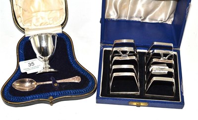 Lot 35 - A cased silver Christening cup and spoons together with two silver toast racks