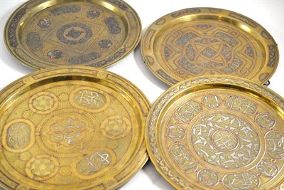 Lot 91 - Four various Cairo Ware brass chargers 36cm, 33cm and 32cm diameter